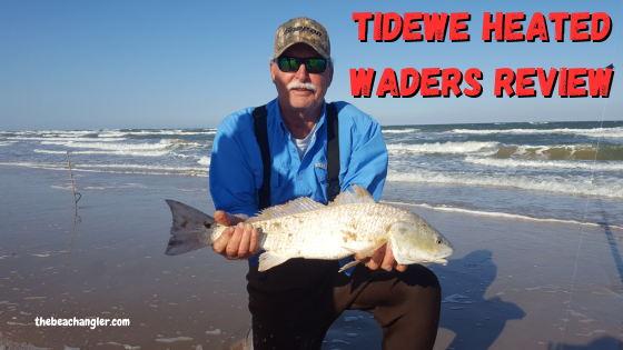 TideWe waders review - Ken Kuhn kneeling on the beach holding a nice slot red drum while wearing his TideWe neoprene waders