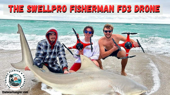 SwellPro Fisherman FD3 fishing drone - three fishermen kneeling behind a large shark on the beach while they hold up the SwellPro FD3 drone.