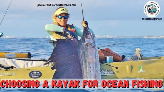 Lady angler holding up a sailfish she caught from her kayak while ocean fishing