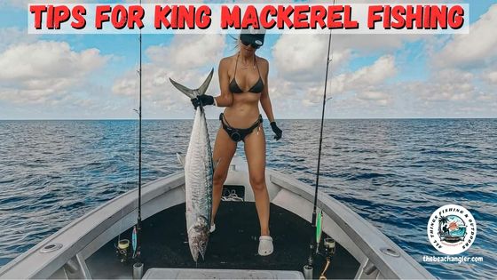 Tips for King Mackerel Fishing - Lady angler standing in the bow of a boat holding up a large king mackerel by it's tail