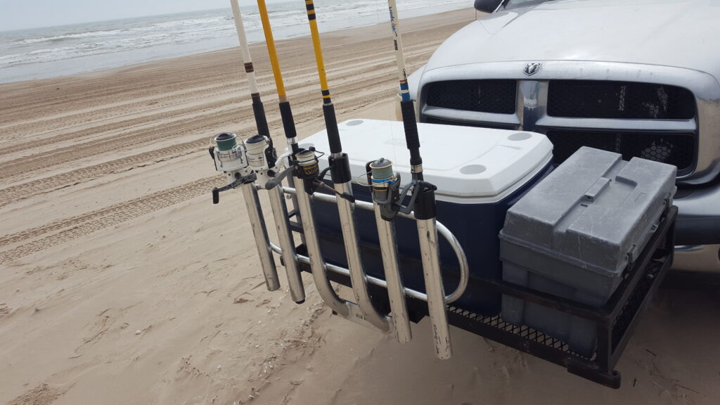 Photo of saltwater rods and reels in a bumper mounted rod rack on the beach
