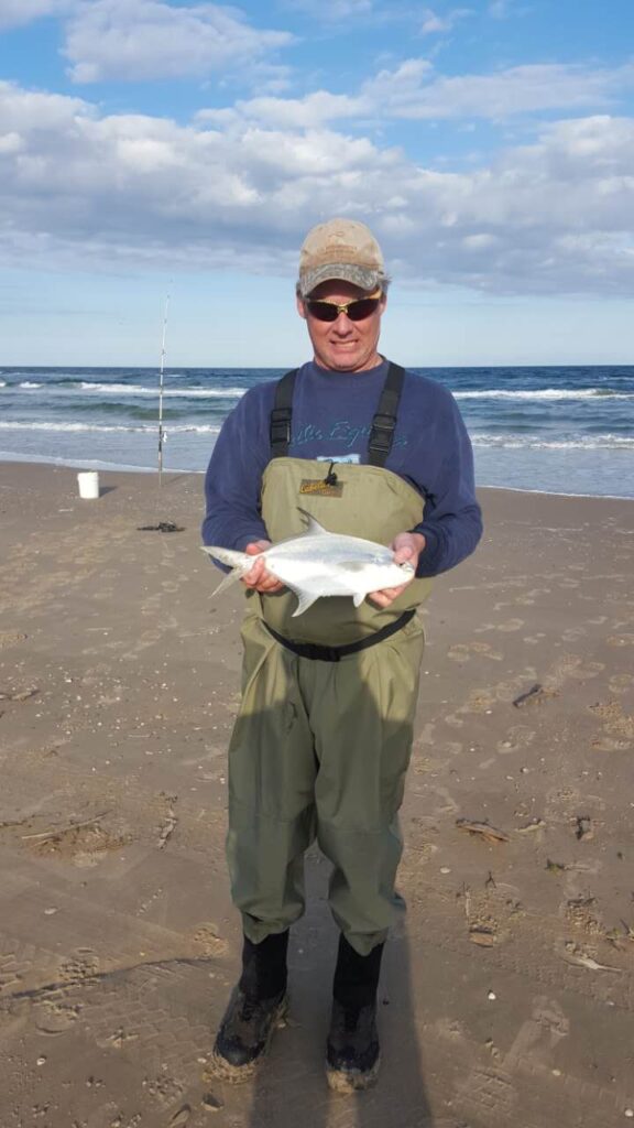 surf fishing in winter - Author with a wintertime Florida pompano caught surf fishing in winter