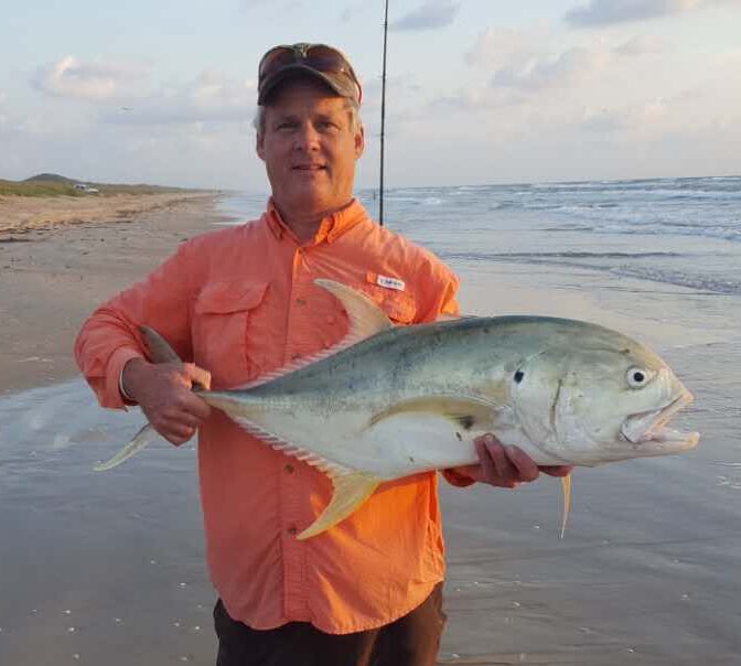 Rex McMahon holding a large Jack Crevalle on the beach
