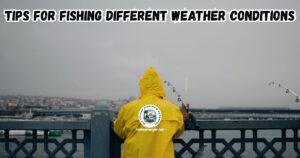 Tips for Fishing in Different Weather Conditions featured image showing a man in a yellow rain suit fishing off a pier while it is raining.