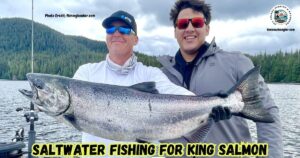 Saltwater Fishing for King Salmon featured image showing two fishermen posing at the back of a boat with a large King Salmon.