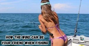 How the Wind can be Your Friend when Fishing Inshore Waters featured image showing a lady angler fighting a fish from the back of a boat on a windy day.
