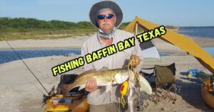 Fishing Baffin Bay, Texas featured image showing Ken Kuhn with a nice slot red drum caught fishing Baffin Bay, Texas.