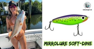 Mirrolure Soft-Dine Lure Review featured image showing lady angler, in a boat, holding a nice slot redfish, next to an enlarged image of the Mirrolure Soft-Dine Lure.